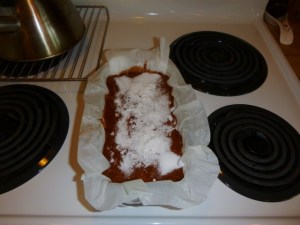 Pound cake batter topped with white sugar and grated coconut before it has been placed in the oven.